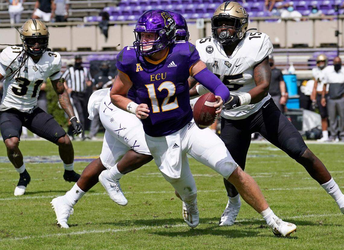 East Carolina quarterback Holton Ahlers (12) scrambles as Central Florida linebacker Tatum Bethune (15) chases during their game in Greenville, N.C., Saturday, Sept. 26, 2020. In eight appearances last season, Ahlers threw 18 touchdowns to nine interceptions and 1921 yards with a 61% completion percentage.
