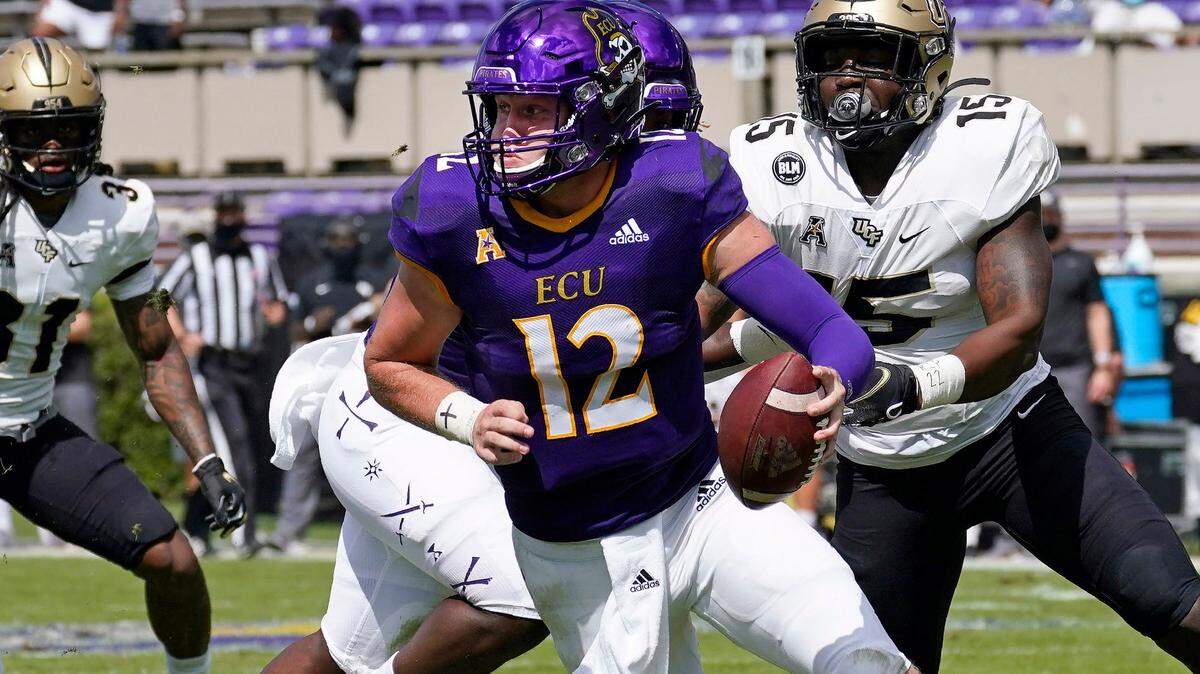 East Carolina quarterback Holton Ahlers (12) scrambles as Central Florida linebacker Tatum Bethune (15) chases during their game in Greenville, N.C., Saturday, Sept. 26, 2020. In eight appearances last season, Ahlers threw 18 touchdowns to nine interceptions and 1921 yards with a 61% completion percentage.