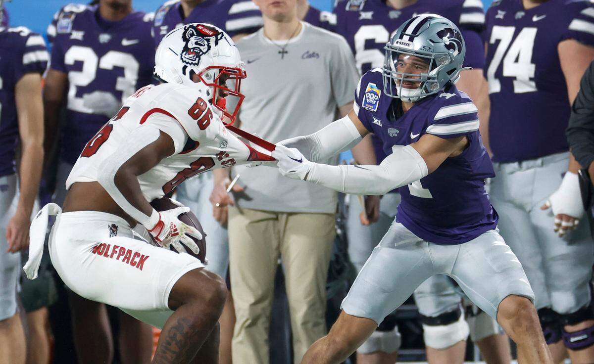 Kansas State cornerback Keenan Garber (1) tackles N.C. State wide receiver Dacari Collins (86) after Collins made a reception during the second half of Kansas State’s 28-19 victory over N.C. State in the Pop-Tarts Bowl at Camping World Stadium in Orlando, Fla., Thursday, Dec. 28, 2023.