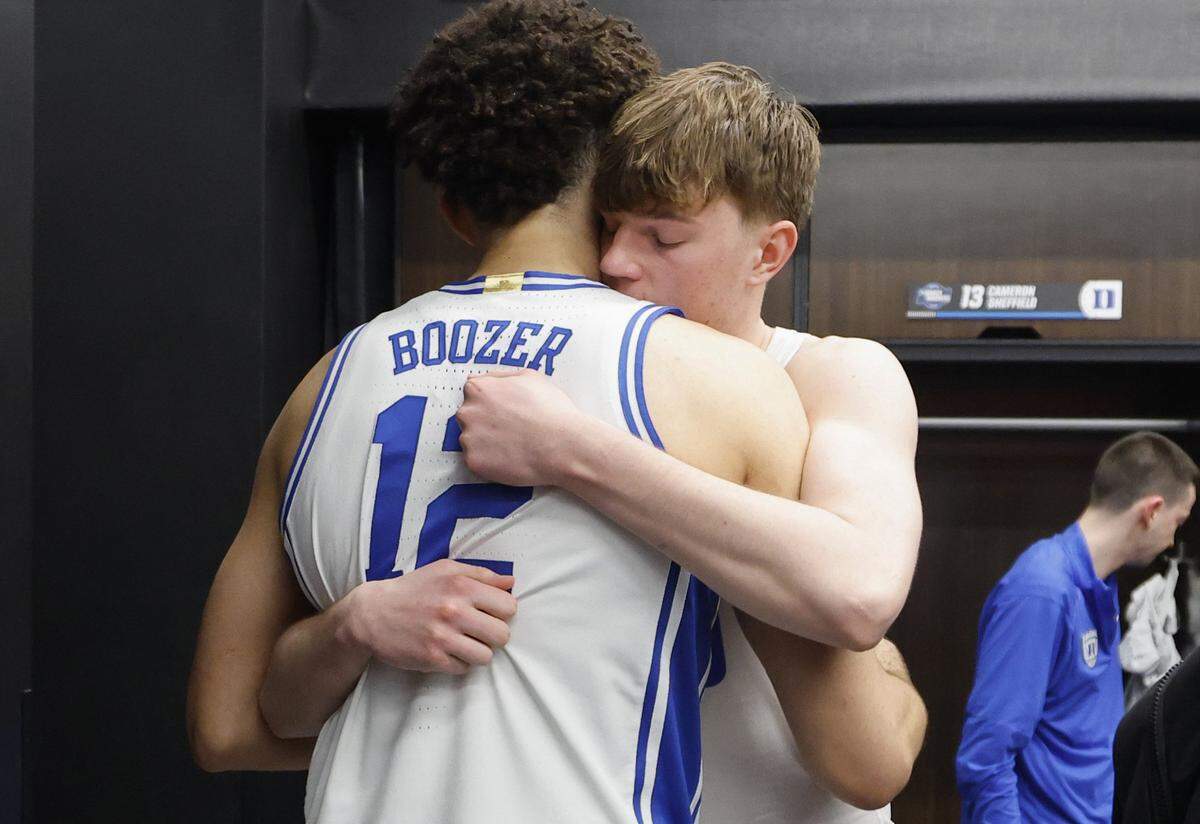 Duke’s Nikolas Khamenia hugs Cameron Boozer  in the locker room after UConn’s 73-72 victory over Duke in the NCAA Men’s Tournament East Regional Final at Capital One Arena in Washington, D.C., Sunday, March 29, 2026.