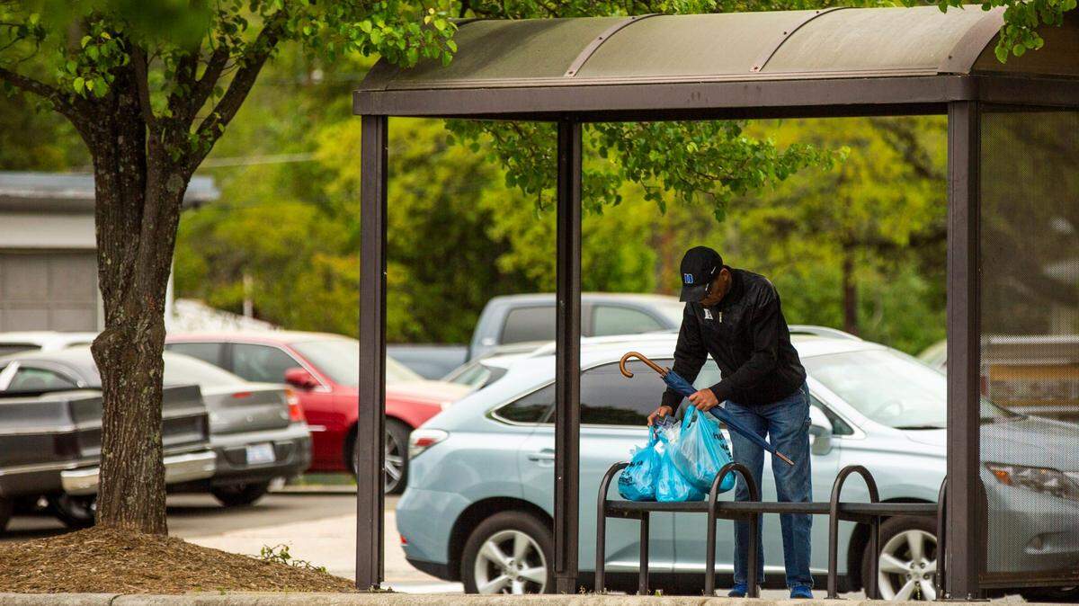 Oscar Dantzler, 68, sets down groceries he bought from Food Lion to wait for a GoDurham bus, on Mar. 31, 2020. GoDurham is gradually improving its bus stops, with new shelters, benches and other upgrades.