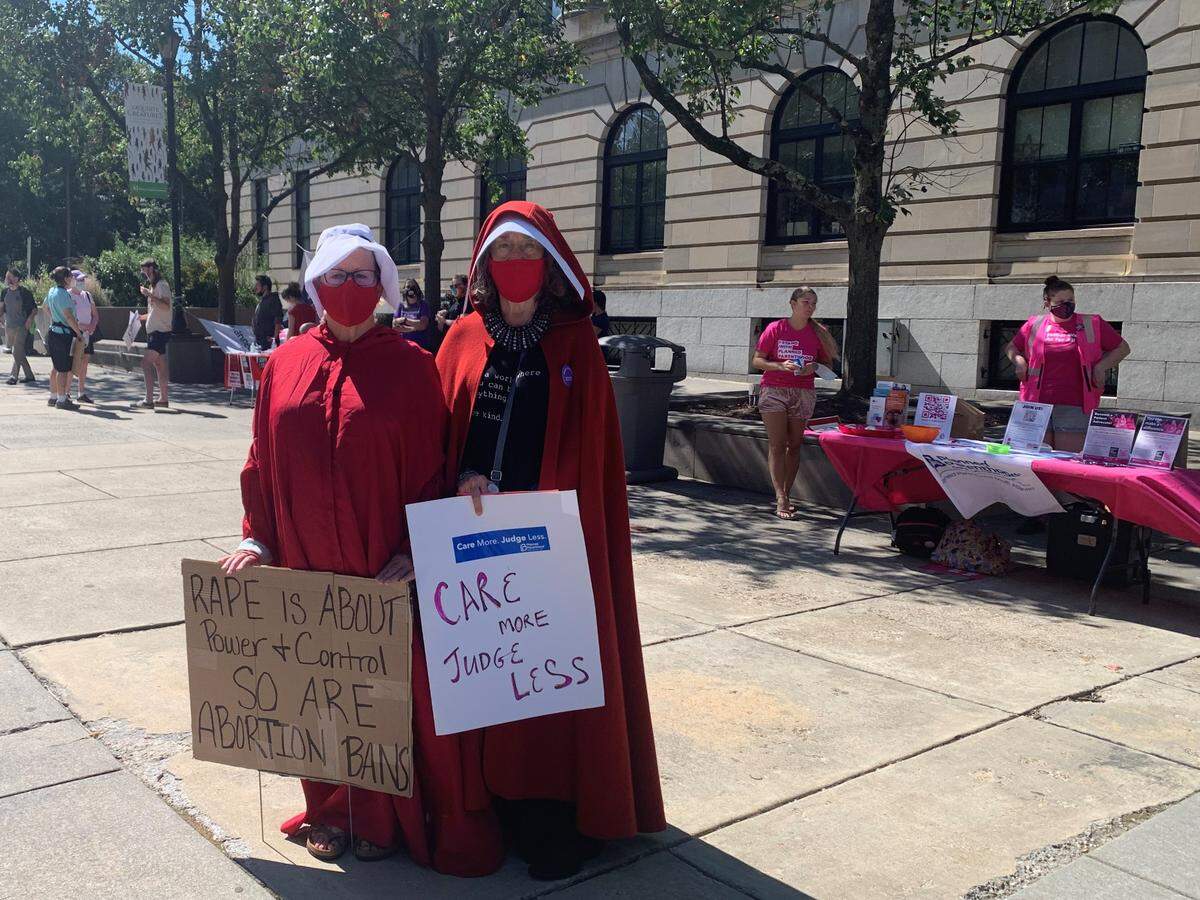 Darcey Moore, 63, at left, and Gayle Grigson, 72, wore red cloaks fashioned after “The Handmaid’s Tale,” to protest anti-abortion legislation at a Raleigh demonstration on Saturday, Oct. 2.