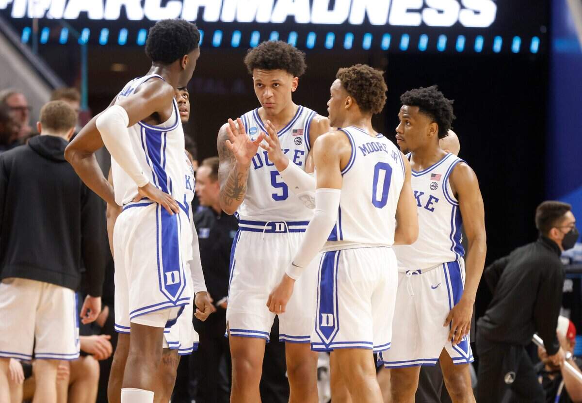 The team huddles during the first half of Dukes game against Arkansas in the NCAA Tournament West Regional finals at the Chase Center in San Francisco, Calif., Saturday, March 26, 2022.