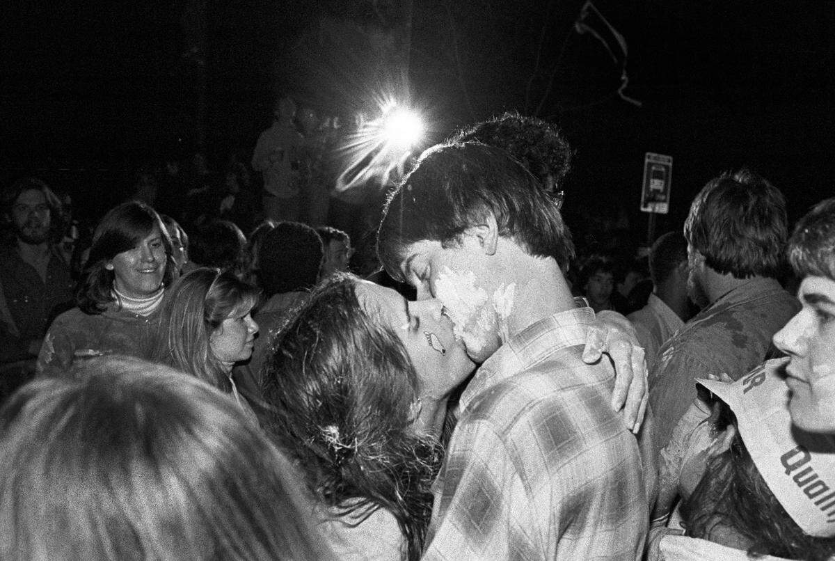A couple kisses in the middle of the celebration on Franklin Street in Chapel Hill, NC after the Tar Heels defeated Georgetown to win the 1982 National Championship.