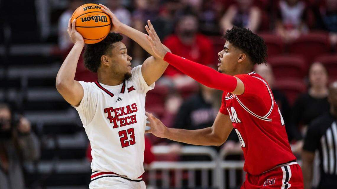 LUBBOCK, TEXAS - DECEMBER 21: Eemeli Yalaho #23 of the Texas Tech Red Raiders handles the ball against Adam Hamilton #20 of the Lamar Cardinals during the first half at United Supermarkets Arena on December 21, 2024 in Lubbock, Texas. (Photo by John E. Moore III/Getty Images)
