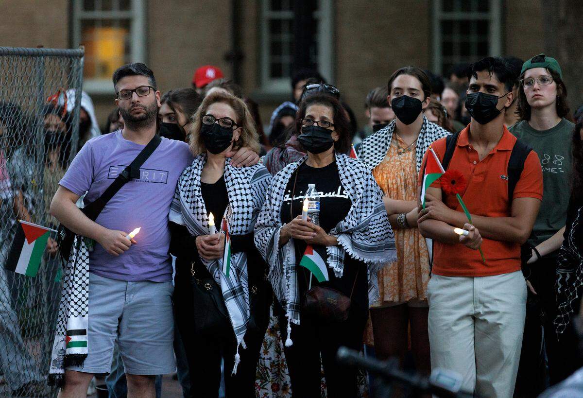 People listen during a vigil held by the UNC chapter of Students for Justice in Palestine on Monday, Oct. 7, 2024, in Chapel Hill, N.C. The vigil was intended to honor those who have been killed during Israel’s counter-campaign against Hamas in the past year.