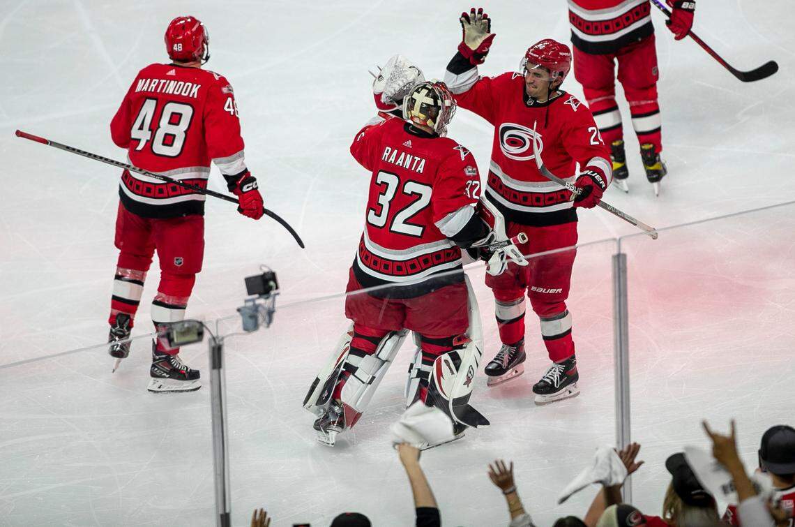 Carolina Hurricanes goalie Antii Raanta (32) is congratulated by teammate Seth Jarvis (24) after making 23 saves in the Hurricanes’ 4-3 victory victory over the New York Islanders on Wednesday, April 19, 2023 at PNC Arena in Raleigh, N.C.