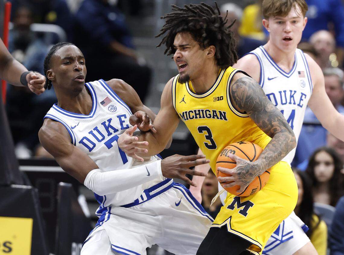 Duke’s Dame Sarr (7) defends Michigan's Elliot Cadeau (3) during the second half of Duke’s 68-63 victory over Michigan in the Capital Showcase at Capital One Arena in Washington, D.C., Saturday, Feb. 21, 2026.