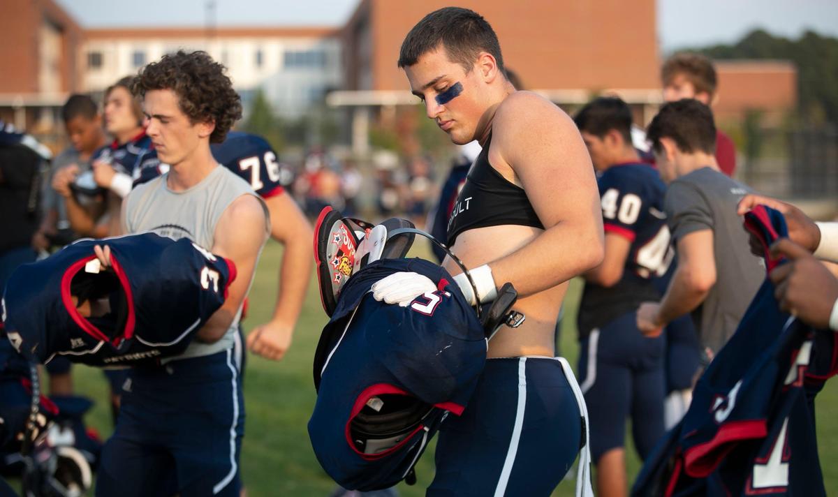 Apex Friendship defensive back Zach Johnson (5) and his teammates suit up for the conclusion of their game against Middle Creek on Monday, September 30, 2019 in Apex, N.C.