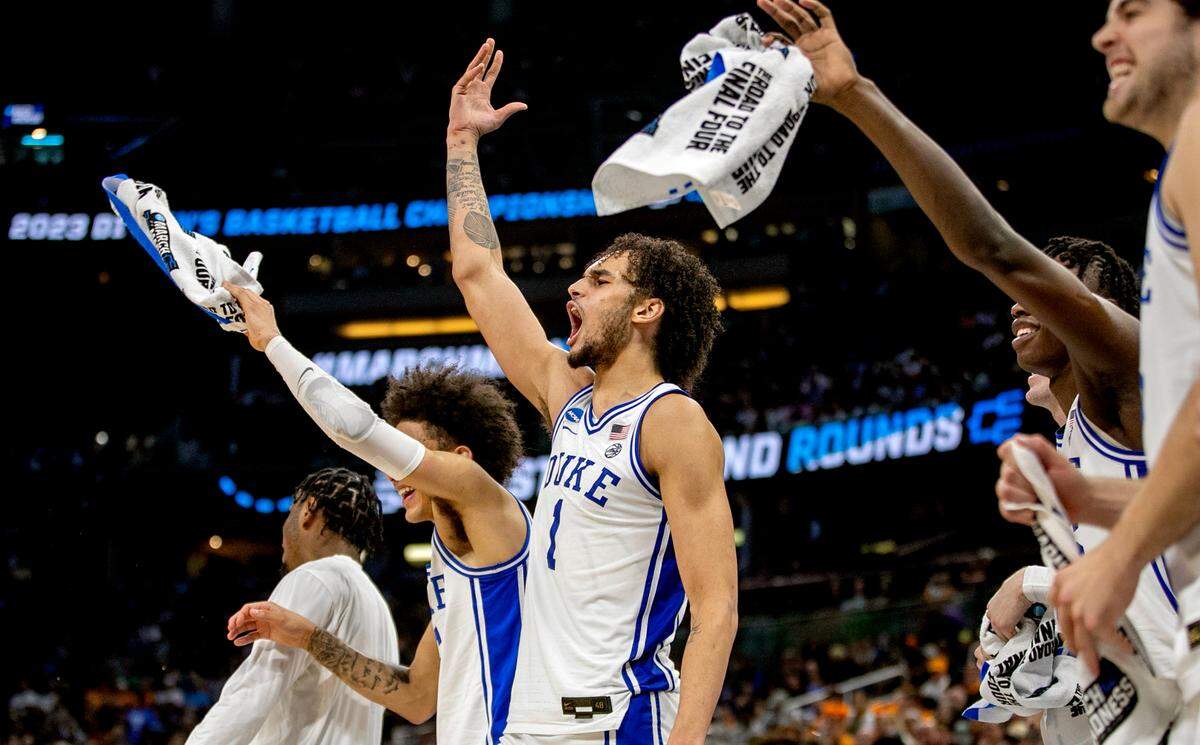 Duke’s Dereck Lively II (1) leads the celebration on the bench after a basket by reserve player Kale Catchings (12) to give the Blue Devils’ a 74-50 lead with :38 seconds to play against Oral Roberts during the first round of the NCAA Tournament on Thursday, March 16, 2023 at the Amway Center in Orlando, Fla.