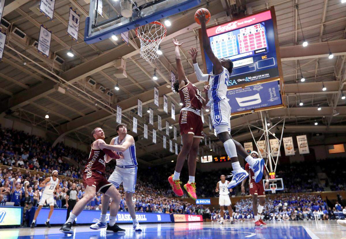 Duke’s Mark Mitchell (25) shoots as Boston College’s Devin McGlockton (21) defends during Duke’s 75-59 victory over Boston College at Cameron Indoor Stadium in Durham, N.C., Saturday, Dec. 3, 2022.