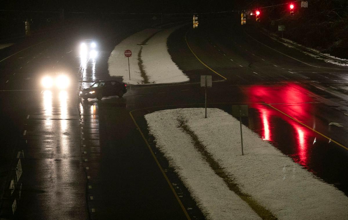 A light dusting of snow blankets only the grassy media on Hammond Road after a winter storm moved through the Triangle  in the early morning hours of Thursday, January 28, 2021in Raleigh, N.C.