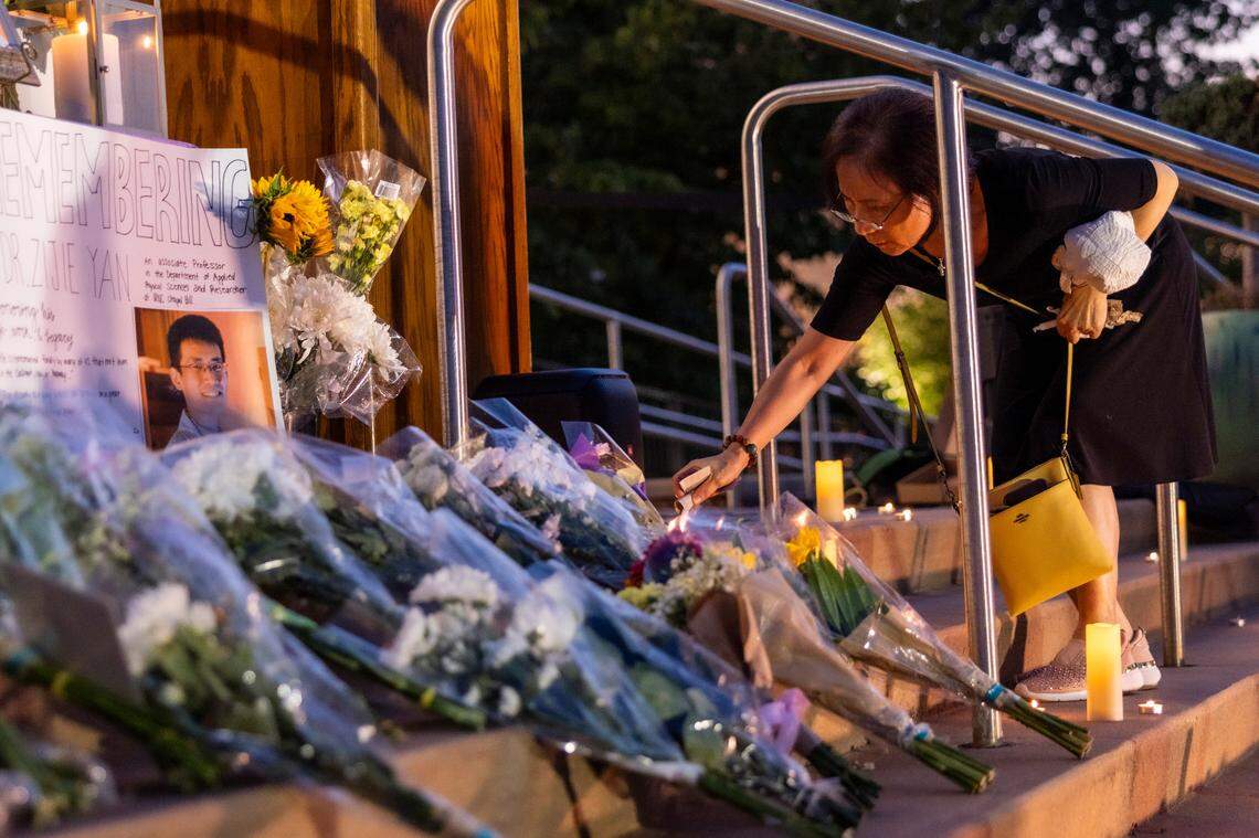 Candles are lit and flowers are laid on the steps of the Cary Arts Center in memory of UNC-Chapel Hill professor Zijie Yan during a candlelight vigil organized by the Chinese American Friends Association of North Carolina and and North Carolina Asian Americans Together on Tuesday evening, Sept. 5, 2023. Yan was shot and killed on campus on Monday, Aug. 28.