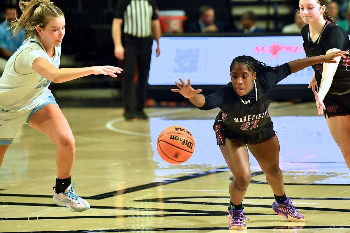 Wakefield’s Maddison McIntyre (22) dives for the ball against Hoggard’s Avery Fitzgerald (23) in the second half. The Wakefield Wolverines and the Hoggard Vikings met in the NCHSAA 4A East Regional Final in Winston-Salem, N.C. on March 12, 2025. Wakefield wins 31-23.