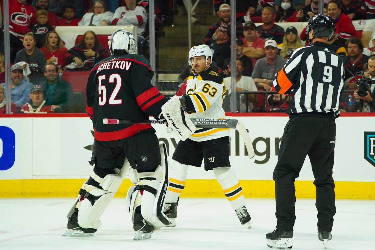 Boston Bruins left wing Brad Marchand (63) swings his stick at Carolina Hurricanes goaltender Pyotr Kochetkov (52) during the second period in game two of the first round of the 2022 Stanley Cup Playoffs at PNC Arena.