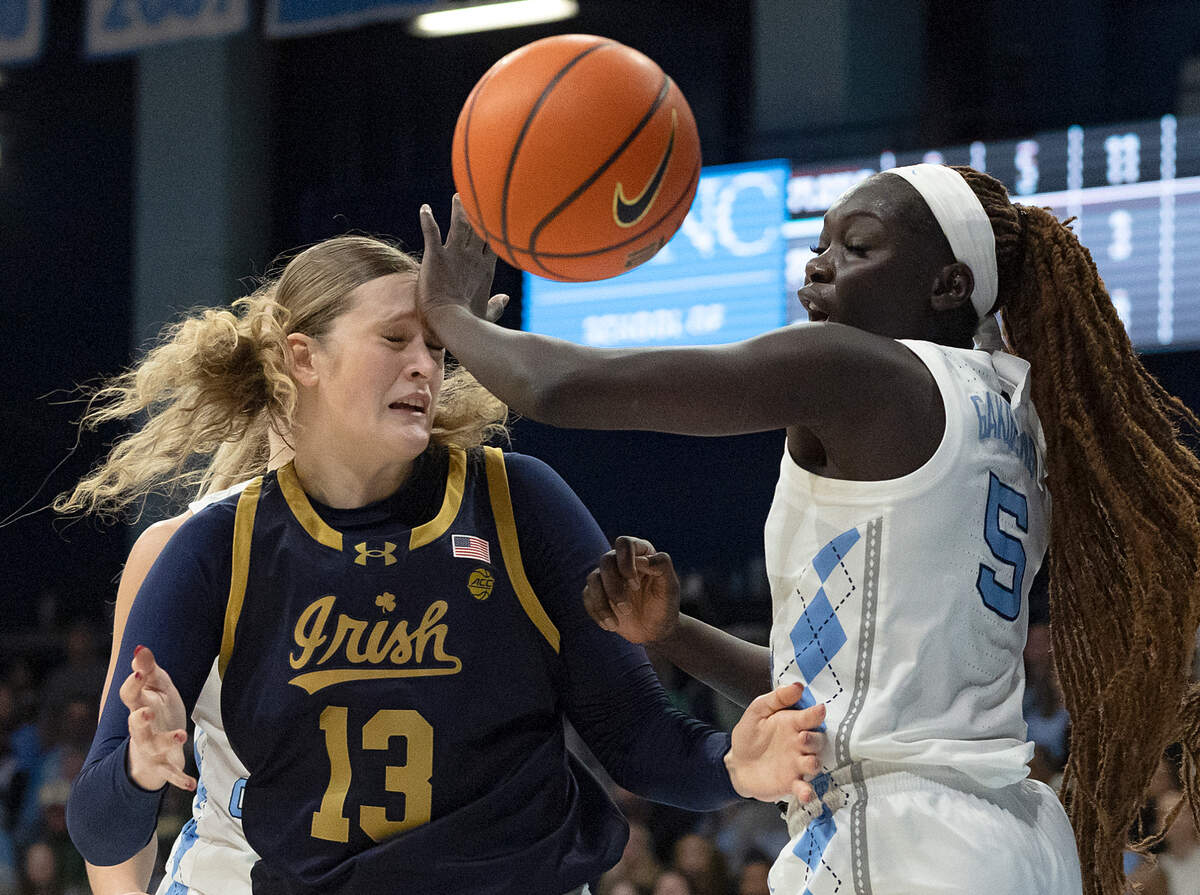 Notre Dame’s Kate Koval and North Carolina’s Maria Gakdeng scramble for a loose ball during the first half of the Tar Heels’ 76-66 loss on Sunday, Jan. 5, 2025, at Carmichael Arena in Chapel Hill, N.C.