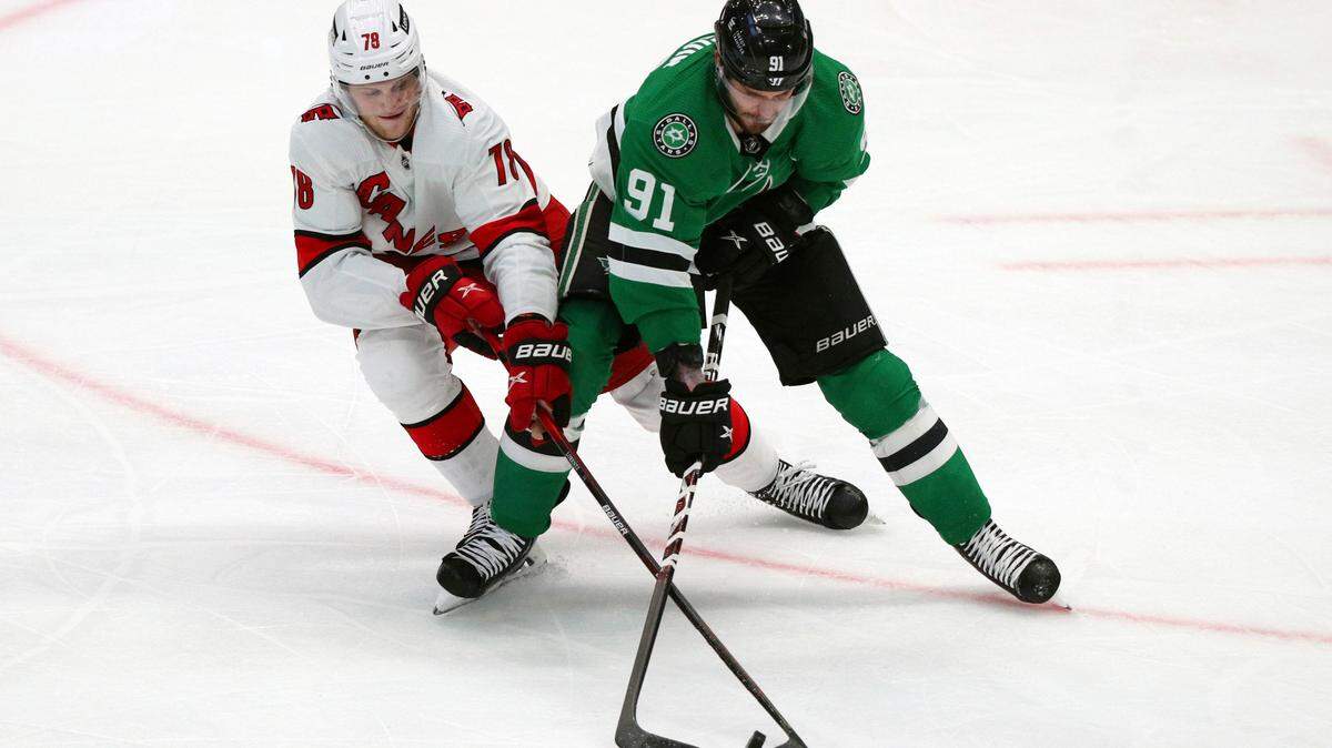 Carolina Hurricanes left wing Steven Lorentz (78) and Dallas Stars center Tyler Seguin (91) battle for the puck in the second period of an NHL hockey game Tuesday, Nov. 30, 2021, in Dallas. (AP Photo/Richard W. Rodriguez)