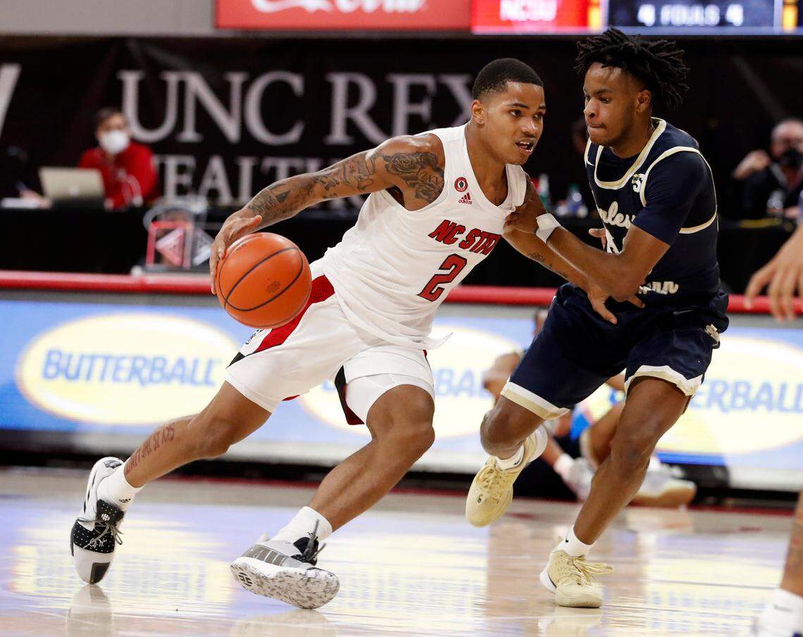 N.C. State’s Shakeel Moore (2) drives around Charleston Southern’s Malik Battle (50) during N.C. State’s game against Charleston Southern in the Wolfpack Invitational at Reynolds Coliseum in Raleigh, N.C., Wednesday, Nov. 25, 2020.