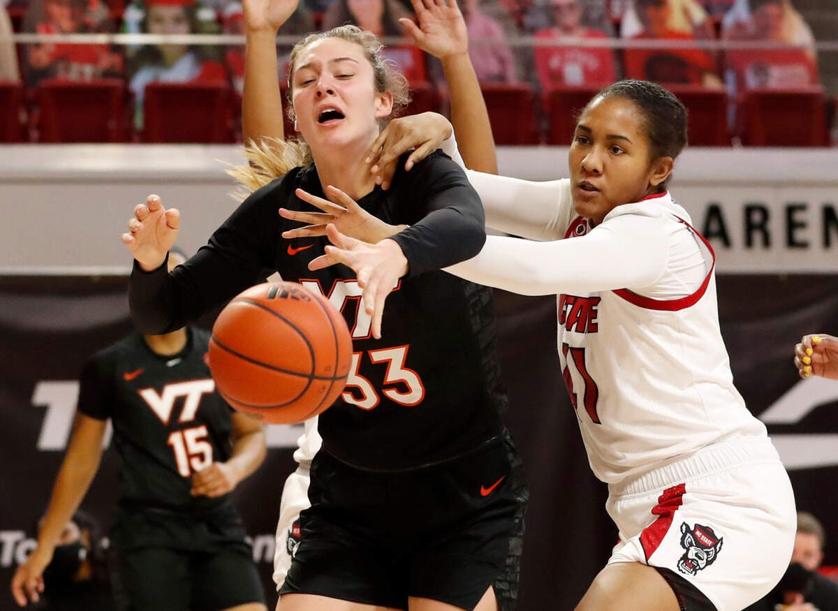Virginia Tech’s Elizabeth Kitley (33), left, and N.C. State’s Camille Hobby (41) go after the rebound during the first half of N.C. State’s game against Virginia Tech at Reynolds Coliseum in Raleigh, N.C., Sunday, January 24, 2021.