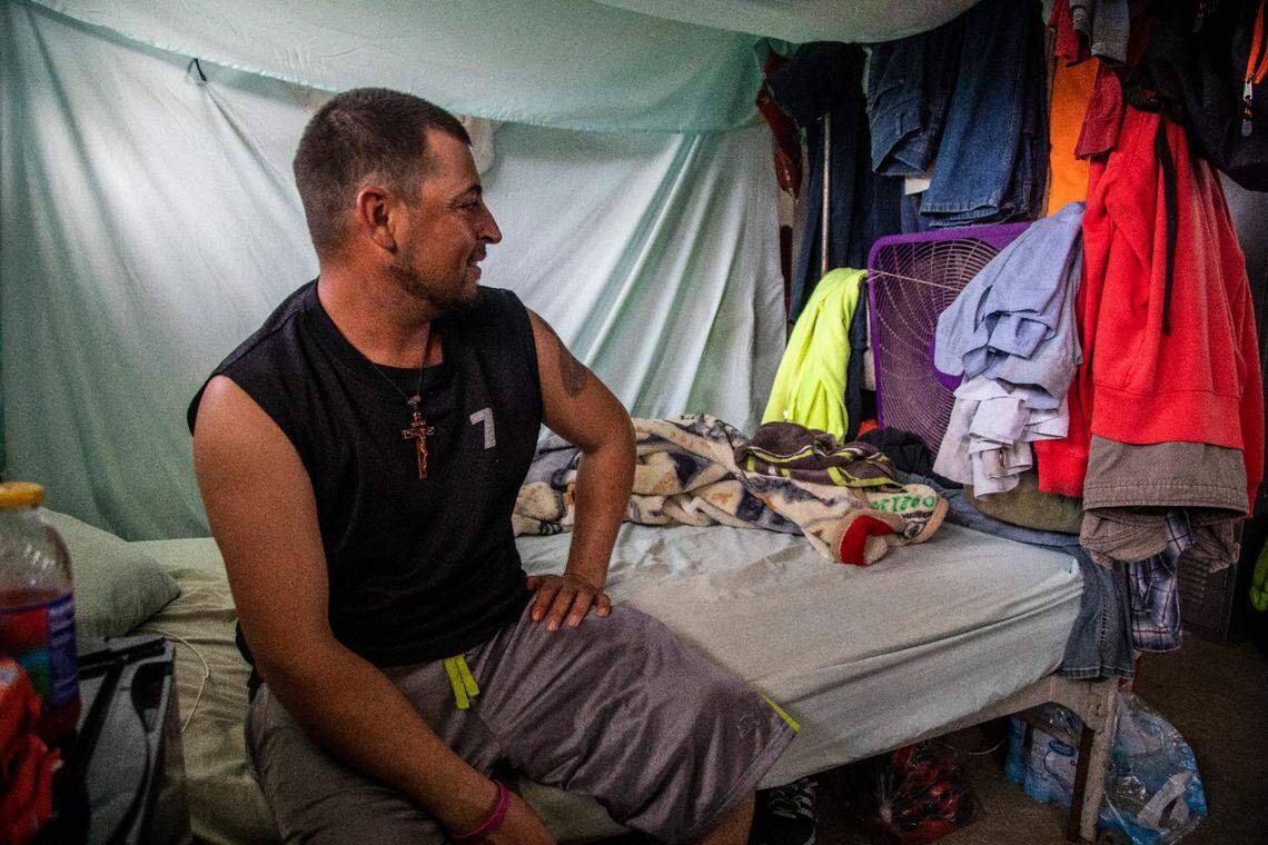 Jos Indalecio, a tractor operator, sits in his living quarters at a Johnston County farmworker camp Thursday August 27, 2020. The camp does not have air conditioning which is considered a luxury by many farmworkers in North Carolina.