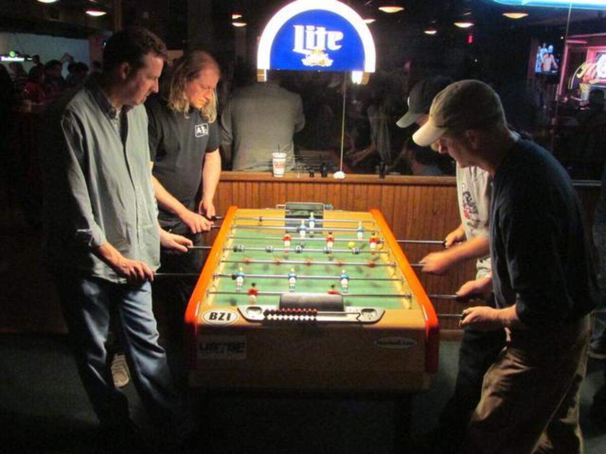 Team PowerKick plays foosball at Fat Daddy’s.