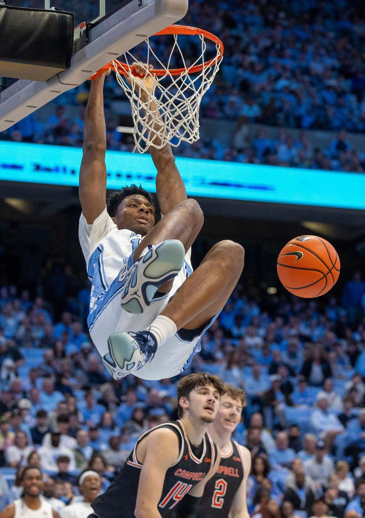 North Carolina forward Jalen Washington (13) dunks over Campbell’s Caleb Zurliene (14) in the second half on Sunday, December 29, 2024 at the Smith Center in Chapel Hill, N.C.