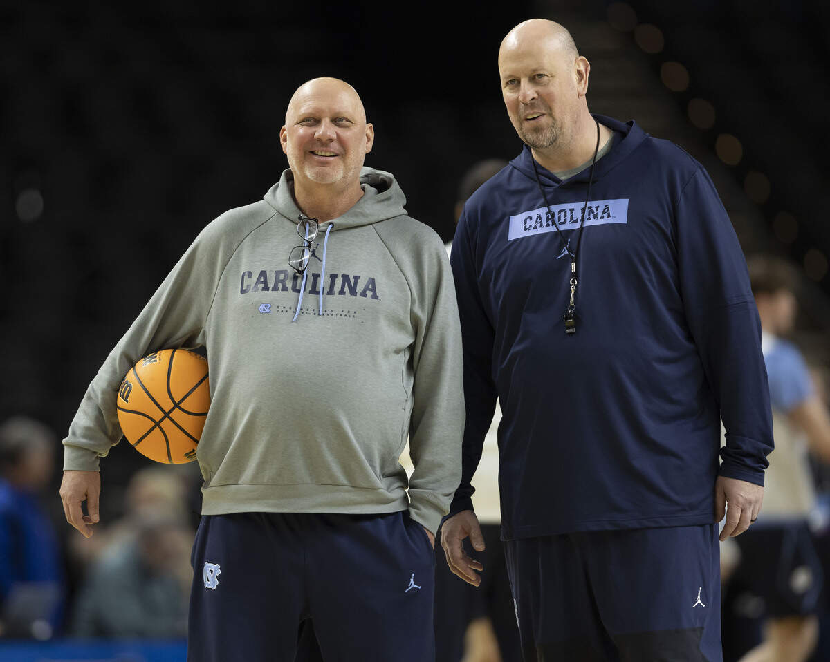 North Carolina assistant coaches Jeff Lebo and Pat Sullivan confer as they watch the Tar Heels practice on Wednesday, March 18, 2026, at Bon Secours Arena in Greenville, S.C.
