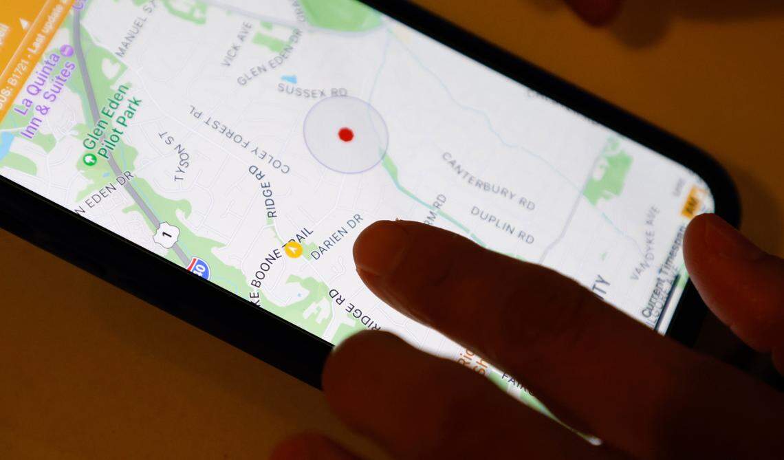 Ilsy Chappell uses an app to check on the location of the school bus that will take her daughter Sienna to Hunter Elementary School in Raleigh, N.C., Tuesday, Jan. 17, 2023.