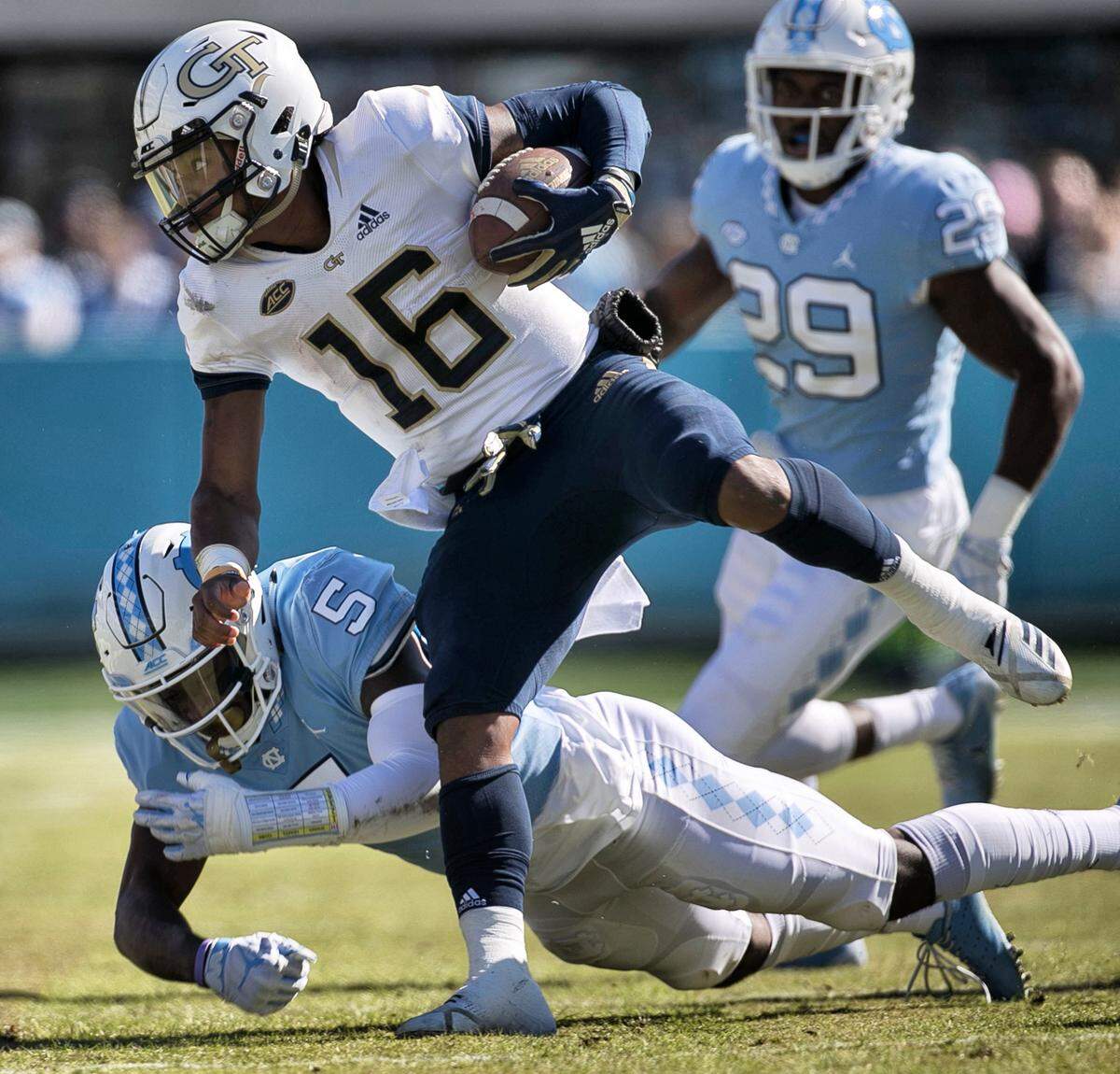 North Carolina’s Patrice Rene (5) works to stop Georgia Tech’s TaQuon Marshall (16) on a four yard gain for a first down in the first quarter on Saturday, November 3, 2018 at Kenan Stadium in Chapel Hill, N.C.