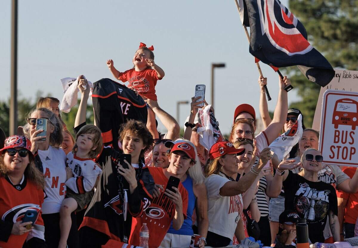 Fans cheer as the Carolina Hurricanes depart Raleigh-Durham International Airport on Monday, June 15, 2026, after the team defeated the Vegas Golden Knights to win the Stanley Cup.