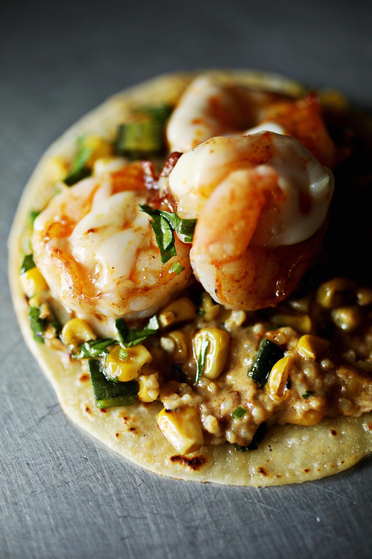 The shrimp & grits taco at 13 Tacos & Taps in North Raleigh is made up of Gulf shrimp with a chorizo and chili pepper sauce, stone-ground NC grits, Oaxaca cheese and green onions wrapped in a corn tortilla.