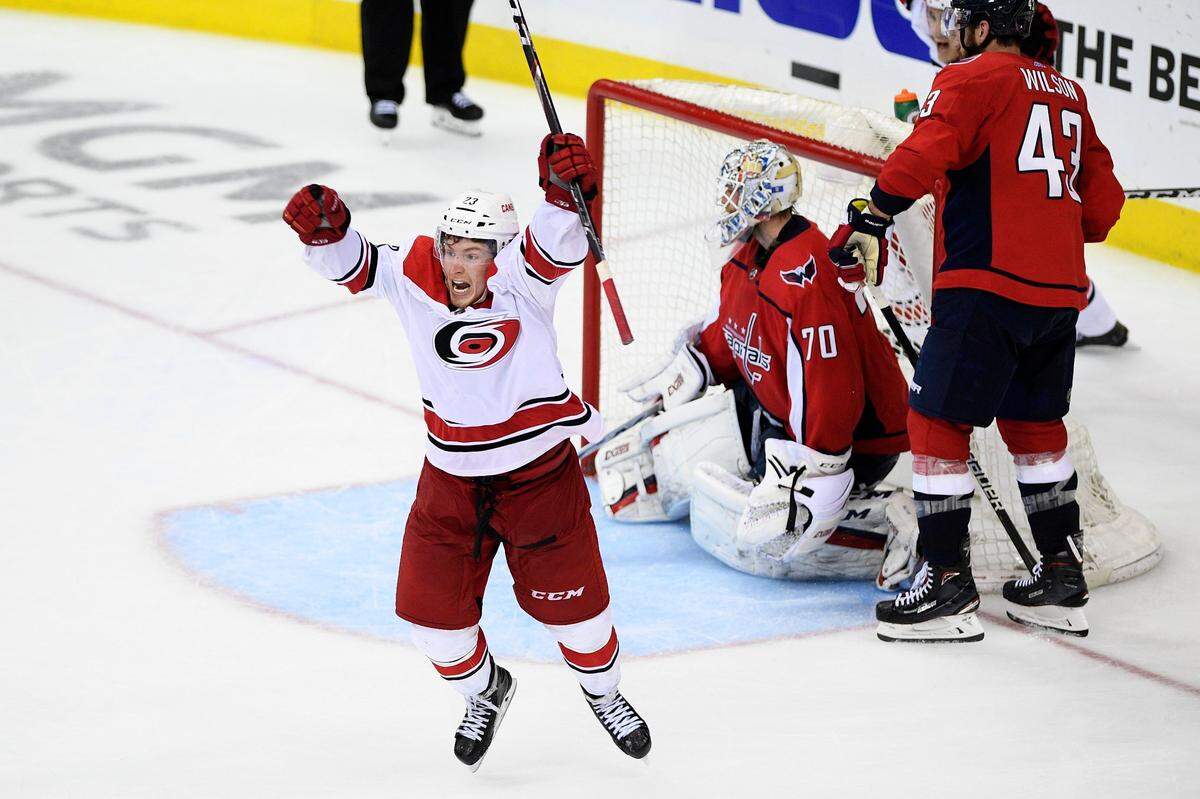 Carolina Hurricanes left wing Brock McGinn, left, celebrates his game-winning goal during double overtime of Game 7 of an NHL hockey first-round playoff series against Washington Capitals goaltender Braden Holtby (70) and right wing Tom Wilson (43), Wednesday, April 24, 2019, in Washington. The Hurricanes won 4-3 in double overtime.