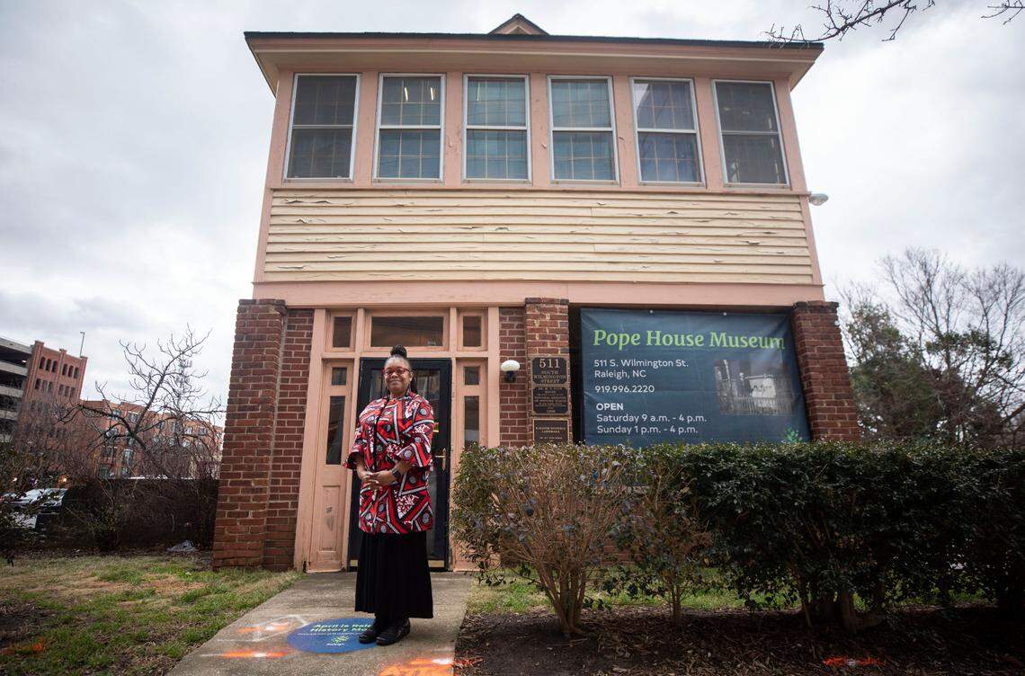 Bettina Pope, the great-grandniece of Dr. Manassa T. Pope, poses for a portrait outside of the Pope House Museum in downtown Raleigh, N.C. on Friday, Feb. 4, 2022.