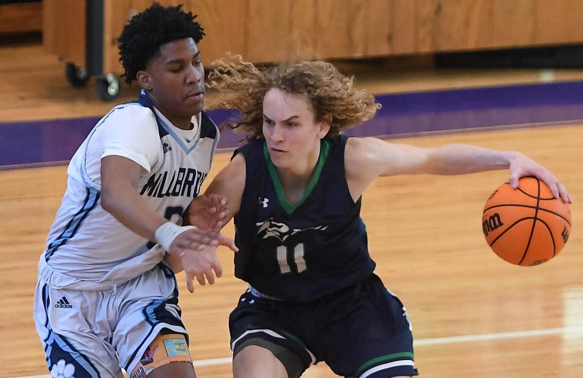 Carter Whitt (11) of Leesville Road dribbles against Silas Demary Jr. , left, of Millbrook. The Leesville Road Pride played the Millbrook Wildcats in a boys basketball game on February 22, 2020.