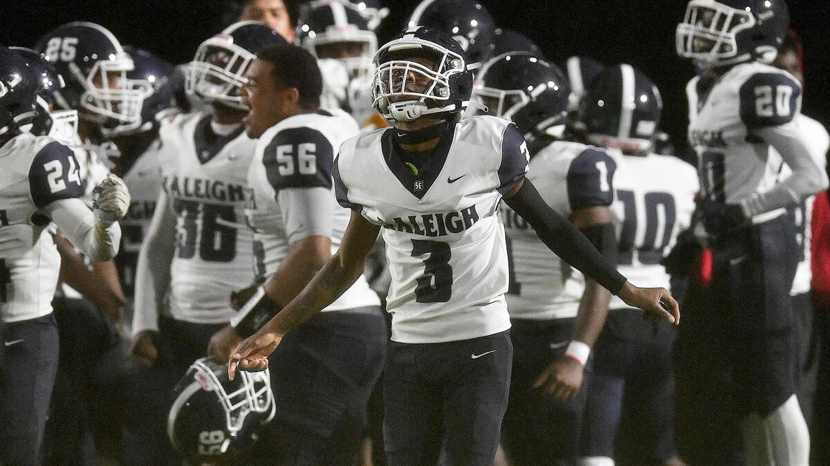 Southeast Raleigh’s Derrick Trice (3) and teammates celebrate after their victory over Fuquay-Varina. The Fuquay-Varina Bengals and the Southeast Raleigh Bulldogs played a conference football game in Fuquay-Varina, N.C. on September 22, 2023.