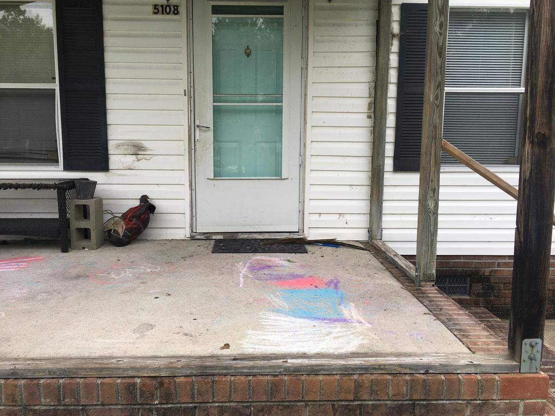 A chalk drawing remains on the front porch of the Wilson house where 5-year-old Cannon Hinnant was shot to death in his front yard.