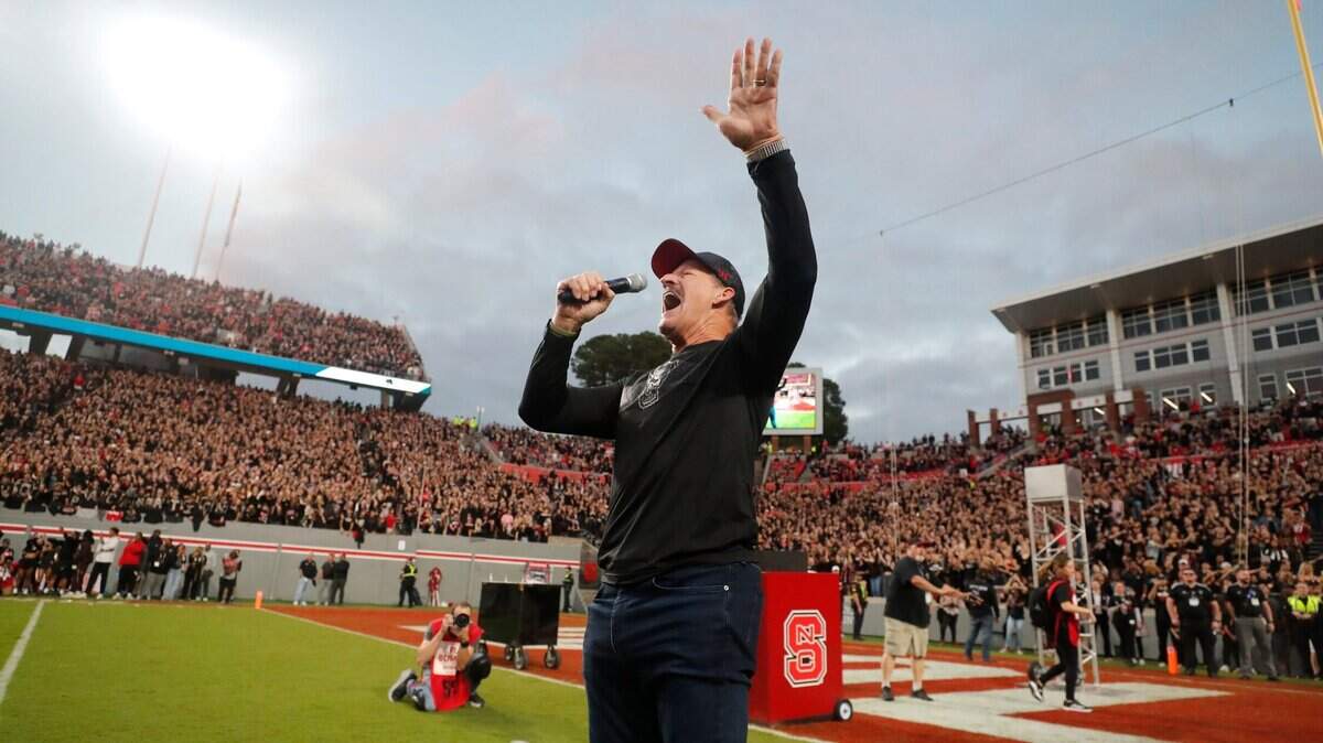 Former N.C. State linebacker Bill Cowher leads the crowd in a Wolfpack chant before the Wolfpack’s game against Louisville at Carter-Finley Stadium in Raleigh, N.C., Friday, Sept. 29, 2023.