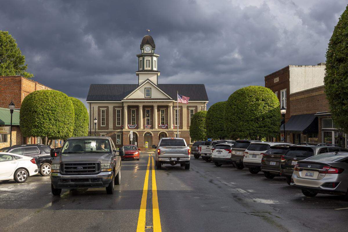 The historic Chatham County Courthouse is all decked out with bunting for the July 4th holiday. Hillsboro Street is aglow after a brief thunderstorm on Thursday July 10, 2025 in Pittsboro, N.C. 