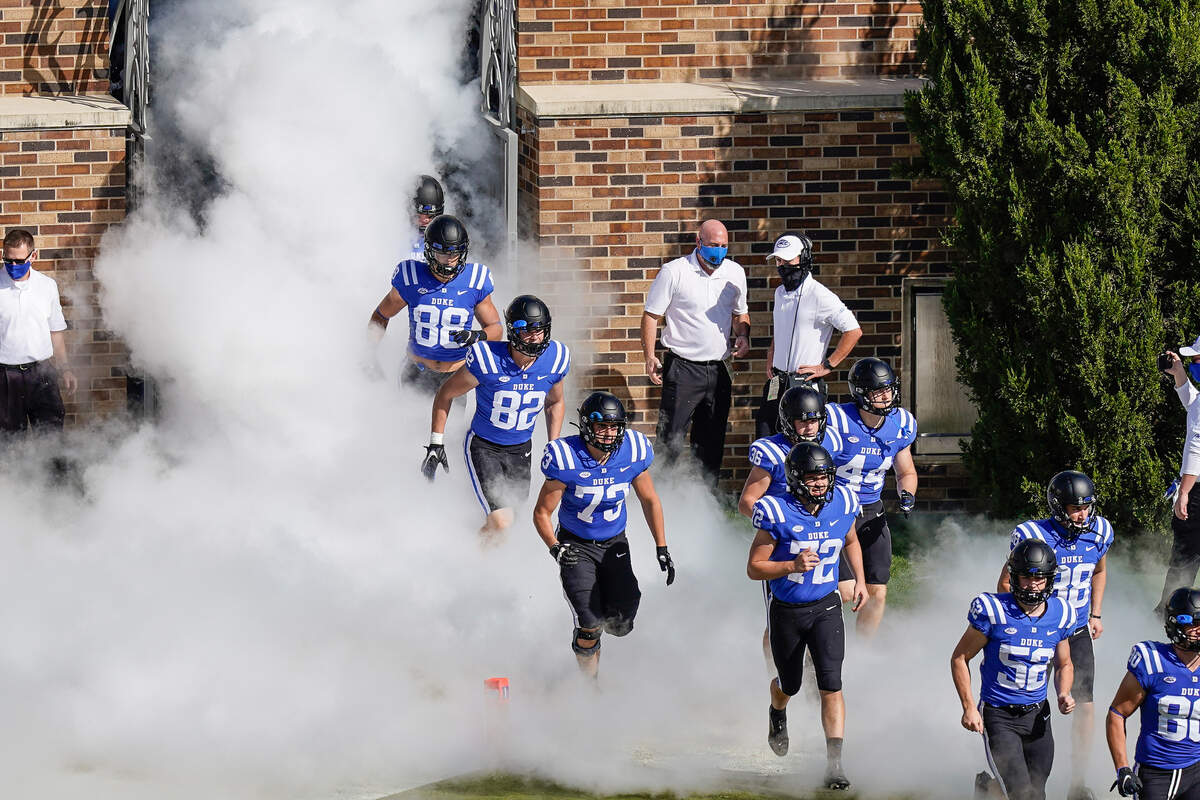 The Duke Blue Devils take the field against the North Carolina Tar Heels during the first quarter at Wallace Wade Stadium.