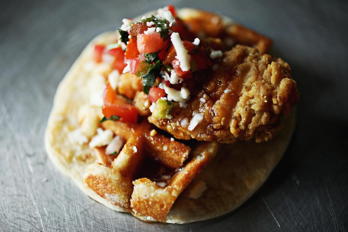 The chicken & waffles taco at 13 Tacos & Taps in North Raleigh is made up of double dipped chicken, smoky maple syrup, pico de gallo and queso fresco atop a waffle and flour tortilla.
