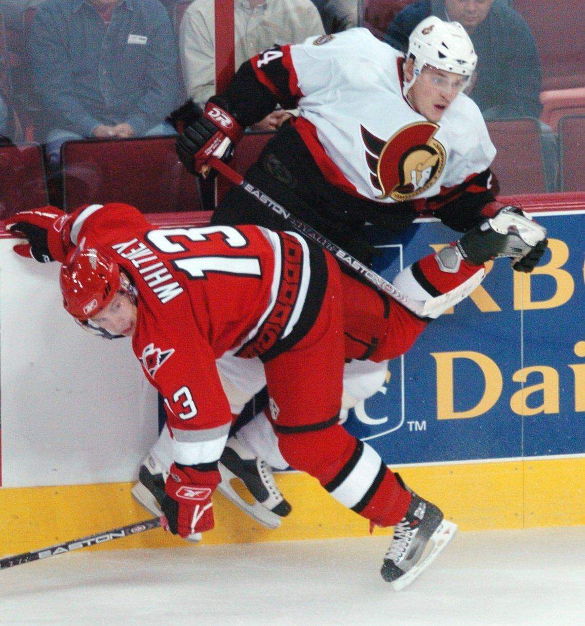 Carolina Hurricanes’ Ray Whitney and Ottawa's Anton Volchenkov collide against the boards Oct. 24, 2005 at the RBC Center, now known as the Lenovo Center. Whitney turned out to be exactly what the Hurricanes needed on and off the ice in the 2005-06 season, a skilled veteran with a loose-cannon personality.