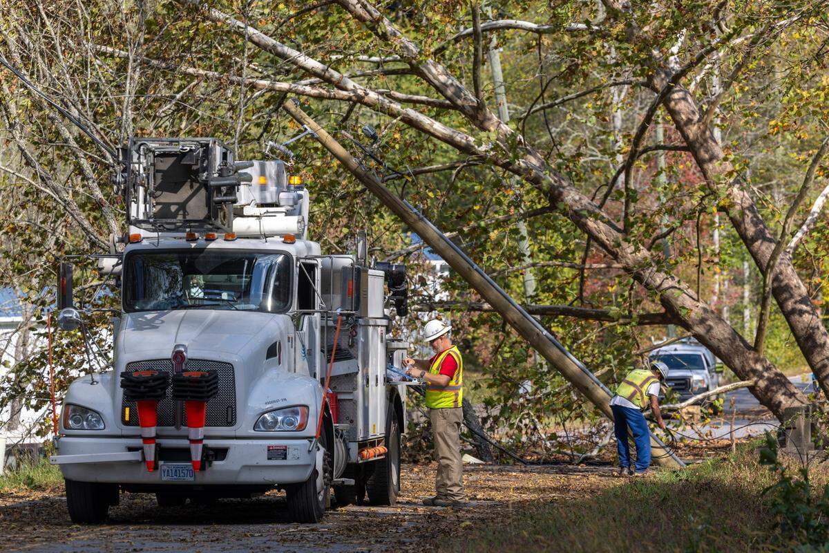 An AT&T crew from Asheville works to restore communication lines along the banks of the Broad River in rural Buncombe County in October 2024.