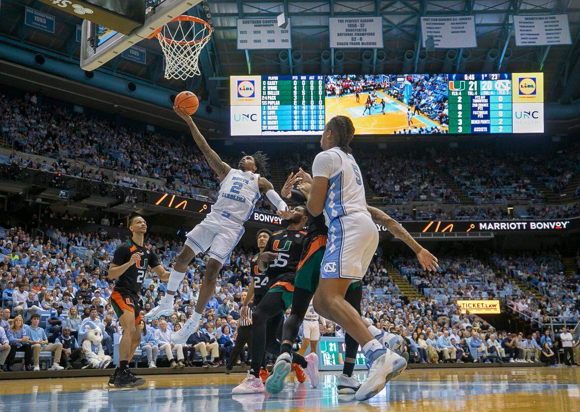 North Carolina’s Caleb Love (2) breaks to the basket past Miami’s Wooga Poplar (55) in the first half on Monday, February 13, 2023 at the Smith Center in Chapel Hill, N.C.