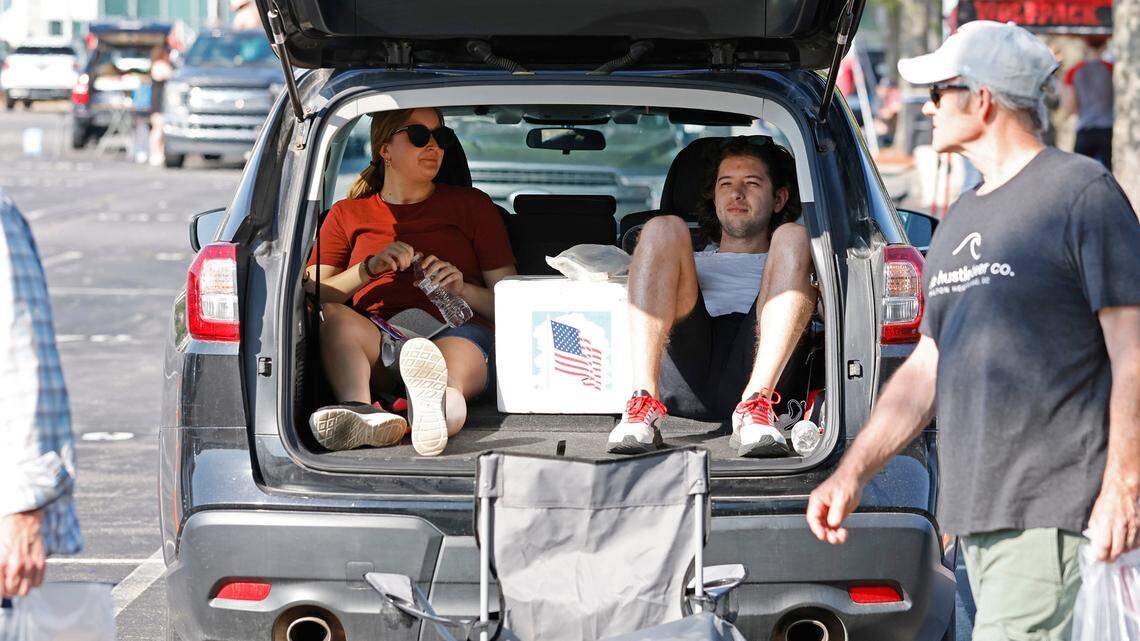 Erin and Ethan Hull of Durham keep cool in their air conditioned Subaru as Carolina Hurricanes fans tailgate before the Canes’ playoff game against the N.Y. Rangers at PNC Arena Friday, May 20, 2022.