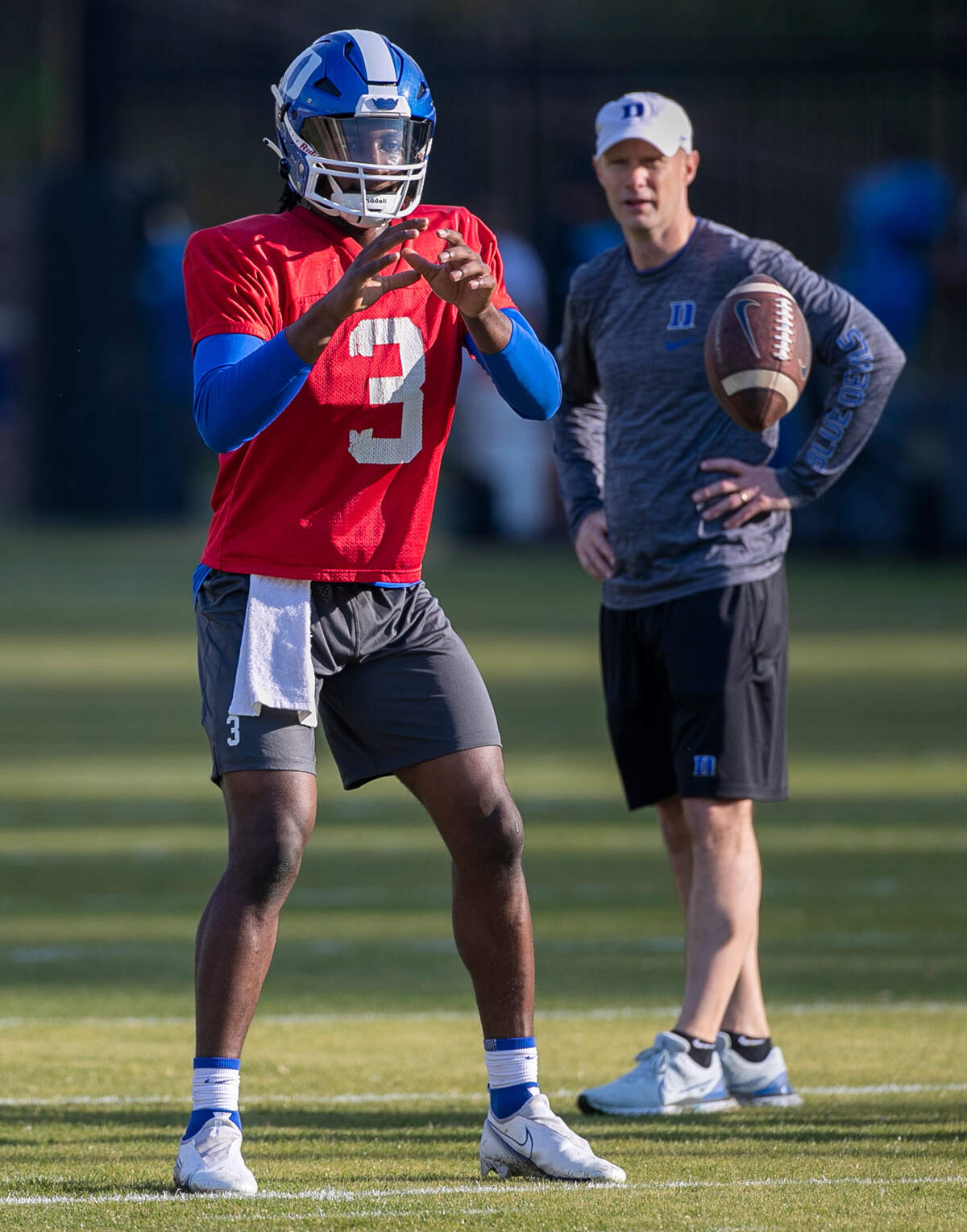 Duke offensive coordinator Kevin Johns watches quarterback Henry Belin IV (3) takes a snap during the Blue Devils’ spring practice on Friday, March 24, 2023 in Durham, N.C.