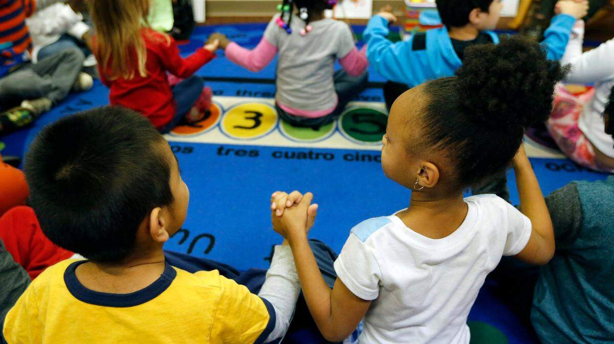 Preschool students join hands during a pre-K program at Hillandale Elementary School in Durham in 2016.