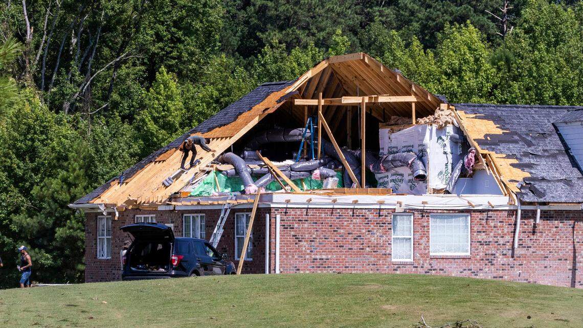 Works help clean up at a heavily damaged homes on Great Glen in the Belmont Lakes Country Club community in Rocky Mount Thursday, July 20, 2023. An EF3, tornado with wind speeds of 150 mph touched down in Nash County Wednesday around 12:30 p.m. Wednesday according to the Raleigh National Weather Service..