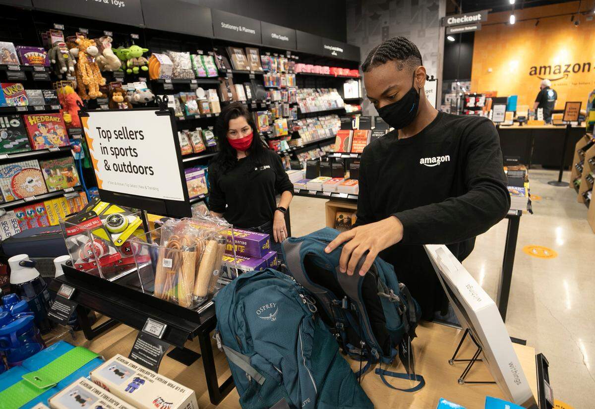 Amazon employee Jaiden Lytch sets up a display of the top sellers in sports and outdoors with Ashlee Demars at Amazon’s 4-star store at Crabtree Valley Mall on Wednesday, October 28, 2020 in Raleigh, N.C.