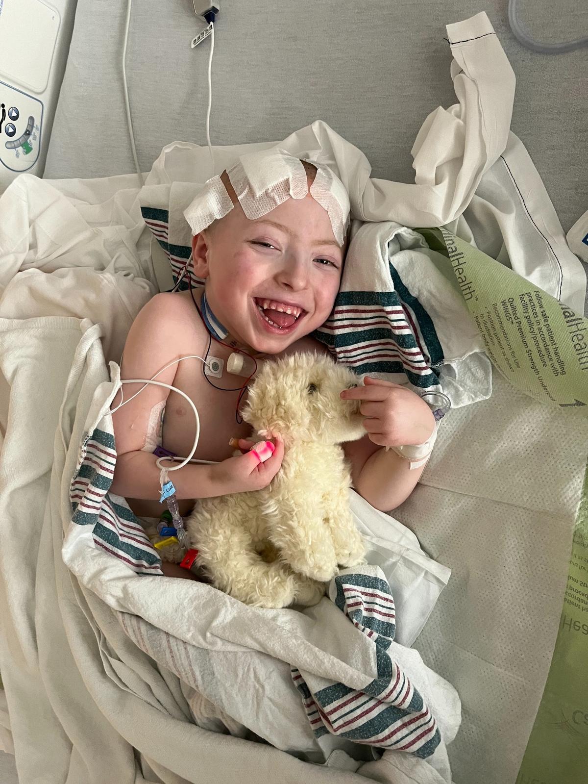 Boston Yannotti, 5, smiles while hugging a stuffed animal on Jan. 20, 2022, the day after receiving gene therapy treatment through surgical delivery at Nationwide Children’s Hospital in Columbus, OH.