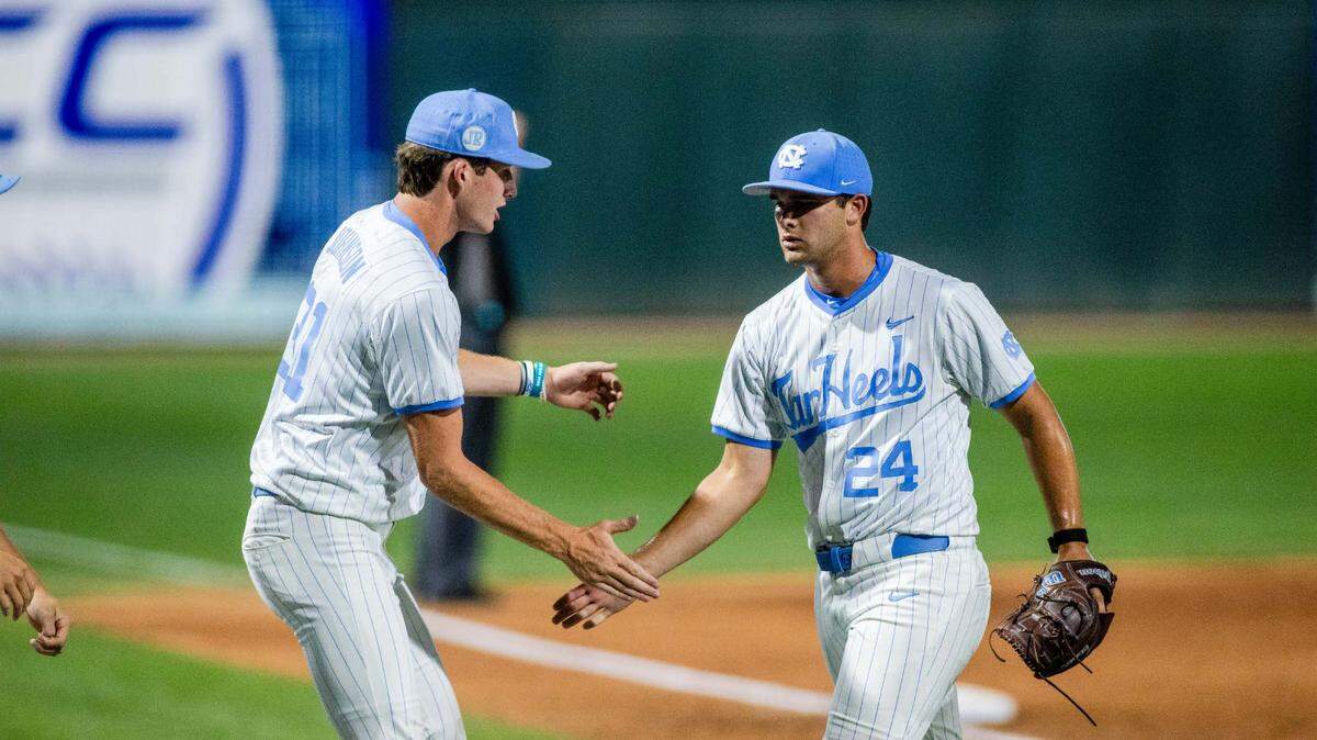 May 24, 2024; Charlotte, NC, USA; North Carolina Tar Heels pitcher Matthew Matthijs (24) is congratulated by pitcher Olin Johnson (31) after the seventh inning against the Wake Forest during the ACC Baseball Tournament at Truist Field.